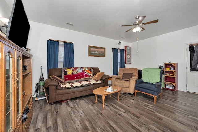 living room featuring dark hardwood / wood-style floors and ceiling fan