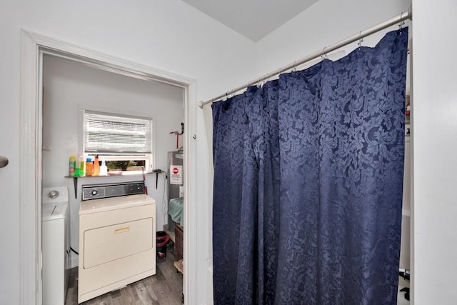 bathroom featuring washing machine and dryer and hardwood / wood-style flooring