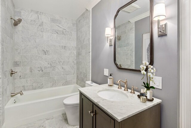 full bathroom featuring vanity, ornamental molding, tiled shower / bath combo, and toilet