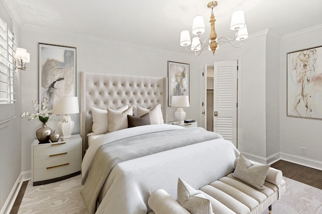 bedroom with hardwood / wood-style floors, a closet, ornamental molding, and an inviting chandelier