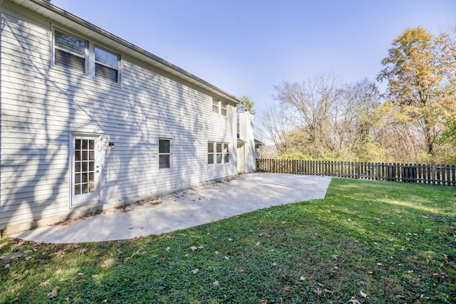 view of side of property with a yard and a patio