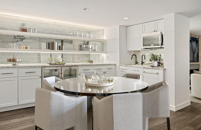 dining area with dark hardwood / wood-style floors and sink