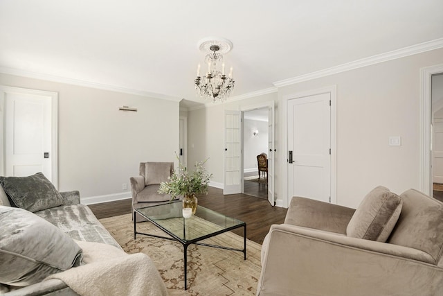 living room with wood-type flooring, crown molding, and a chandelier