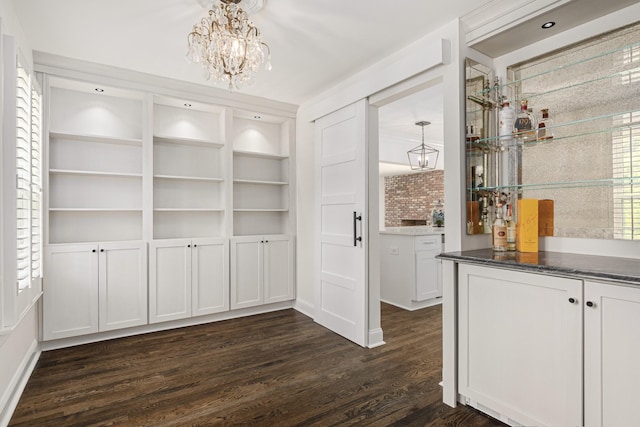 bar with built in shelves, white cabinetry, hanging light fixtures, dark hardwood / wood-style floors, and a chandelier