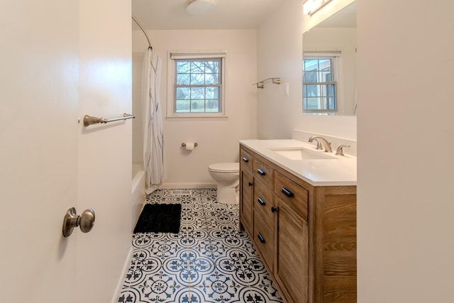 full bathroom with tile patterned floors, vanity, a healthy amount of sunlight, and toilet