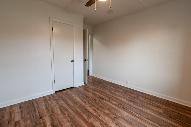 spare room with ceiling fan and dark hardwood / wood-style flooring