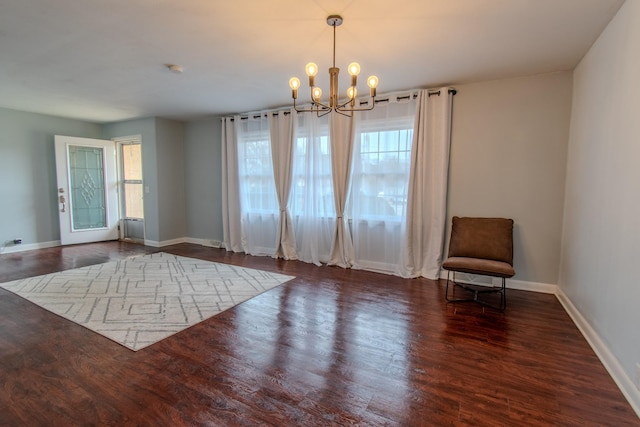 interior space featuring dark hardwood / wood-style flooring and a chandelier