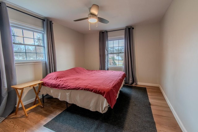 bedroom with ceiling fan and hardwood / wood-style floors