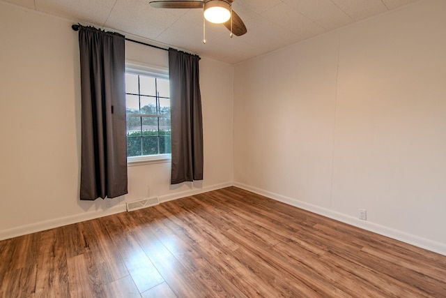 unfurnished room with hardwood / wood-style floors and ceiling fan