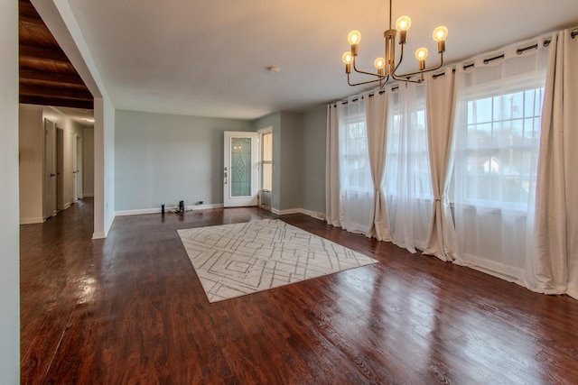 interior space with a chandelier and dark wood-type flooring