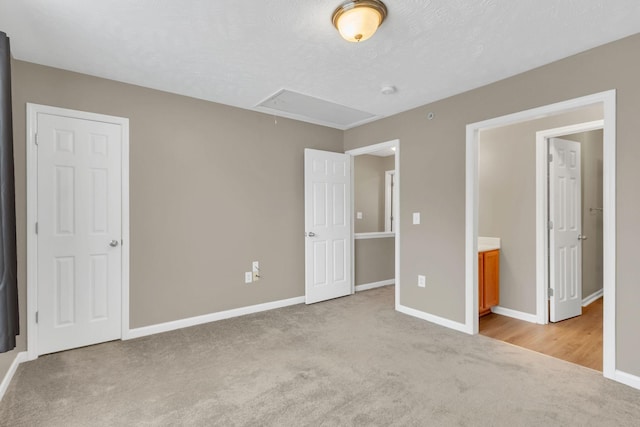 unfurnished bedroom with light carpet and a textured ceiling