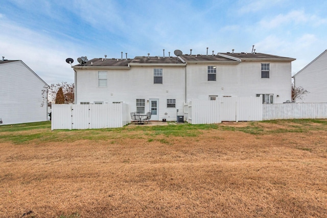 rear view of property with a lawn