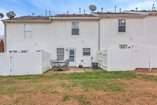 back of house featuring a yard, a patio, and central AC