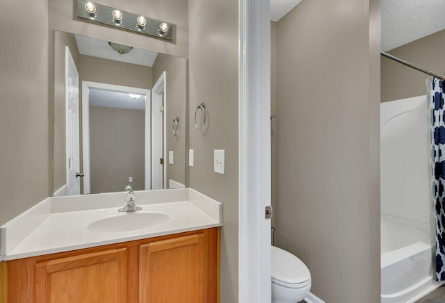 full bathroom featuring vanity, shower / bath combo, toilet, and a textured ceiling