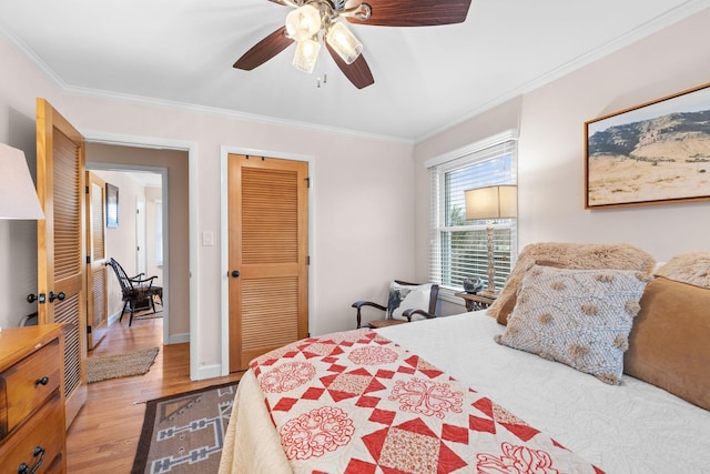 bedroom with a closet, light hardwood / wood-style floors, ceiling fan, and ornamental molding