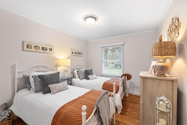 bedroom featuring ornamental molding and hardwood / wood-style flooring