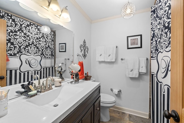 bathroom featuring toilet, vanity, and ornamental molding