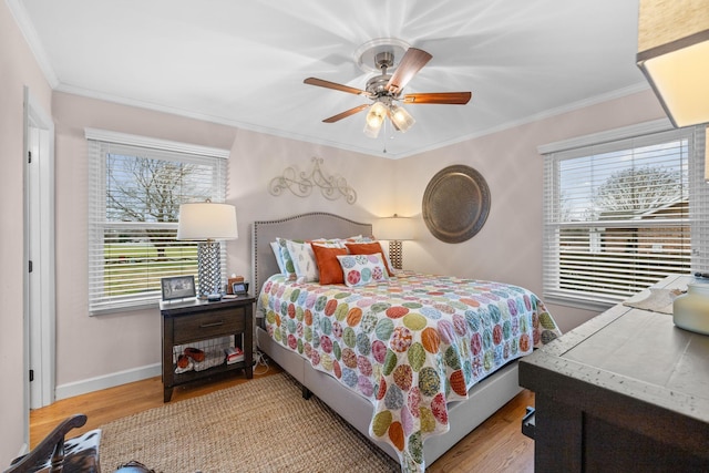 bedroom featuring ceiling fan, crown molding, and light hardwood / wood-style floors