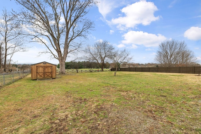 view of yard with a rural view and a shed