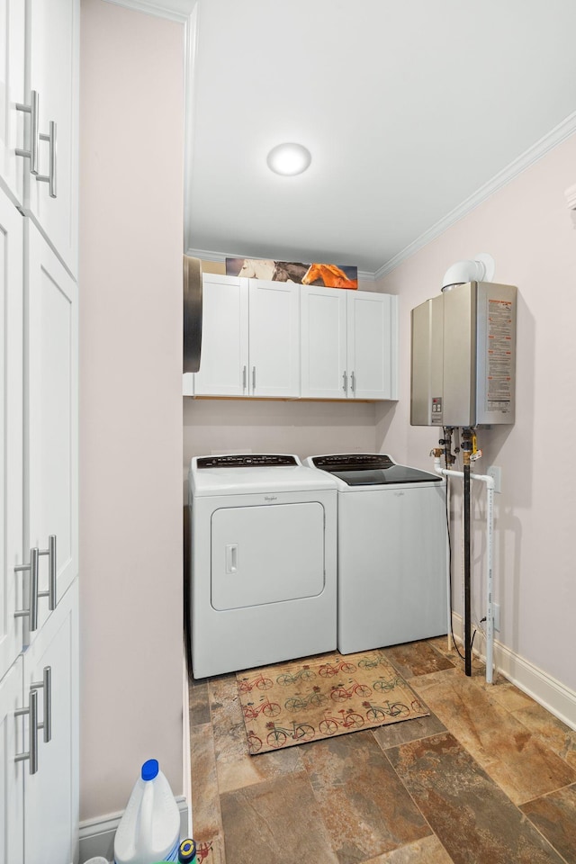 laundry room featuring washer and clothes dryer, cabinets, crown molding, and water heater