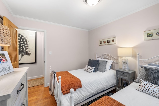 bedroom featuring light wood-type flooring and ornamental molding