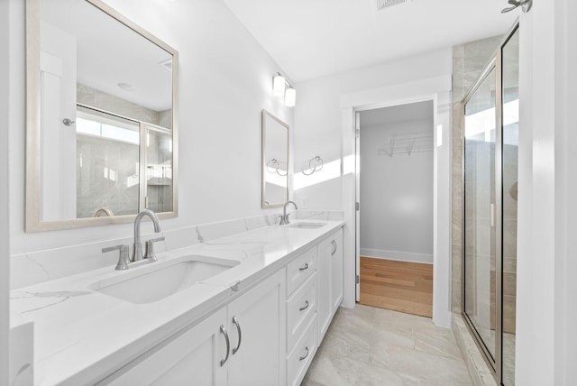 bathroom with an enclosed shower and vanity