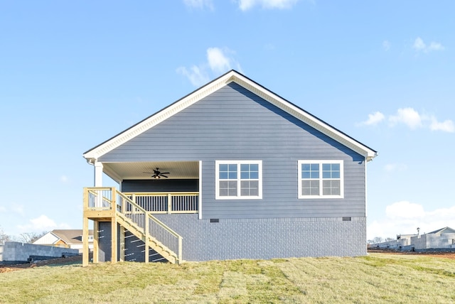 view of home's exterior featuring a yard and ceiling fan