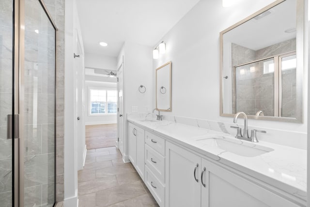 bathroom featuring vanity, tile patterned flooring, and a shower with door