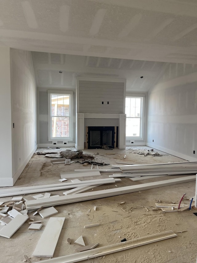 unfurnished living room with a healthy amount of sunlight and a fireplace