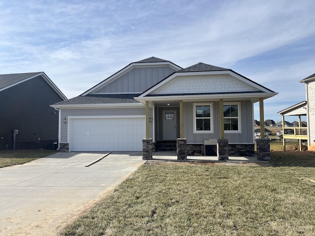 craftsman inspired home with an attached garage, a front yard, board and batten siding, and driveway