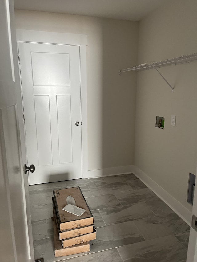 clothes washing area with laundry area, marble finish floor, hookup for a washing machine, and baseboards