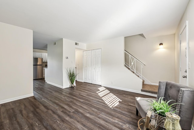 unfurnished living room featuring dark wood-type flooring