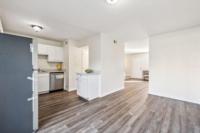 kitchen featuring stainless steel dishwasher, white cabinetry, and hardwood / wood-style floors