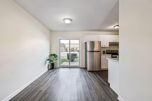 kitchen featuring dark hardwood / wood-style flooring, white cabinetry, and stainless steel appliances