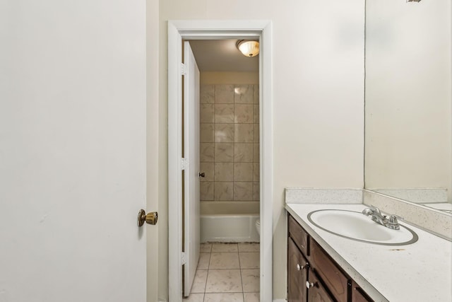 full bathroom featuring tile patterned flooring, vanity, toilet, and tiled shower / bath