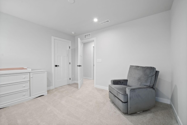 sitting room with light colored carpet