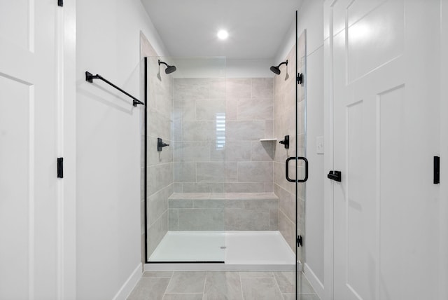 bathroom with tile patterned flooring and a shower with door