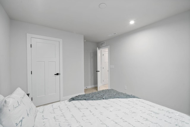 bedroom featuring light colored carpet