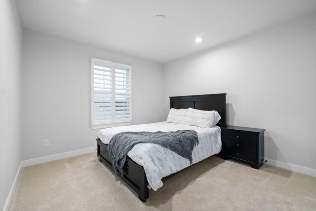 bedroom with light colored carpet