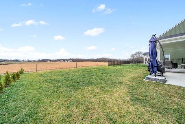 view of yard featuring a rural view and a patio area