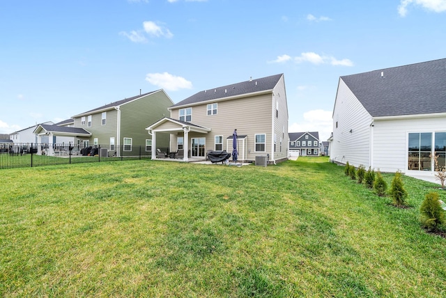 back of house with central AC, a yard, and a patio