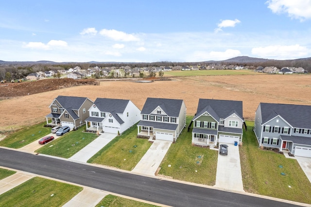 birds eye view of property featuring a mountain view