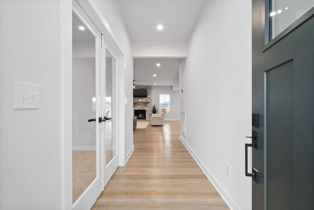 hall featuring french doors and light hardwood / wood-style floors