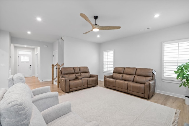 living room featuring ceiling fan and light wood-type flooring