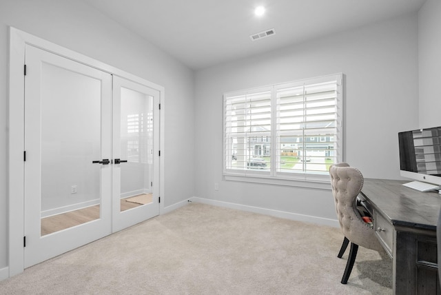 home office with light colored carpet and french doors