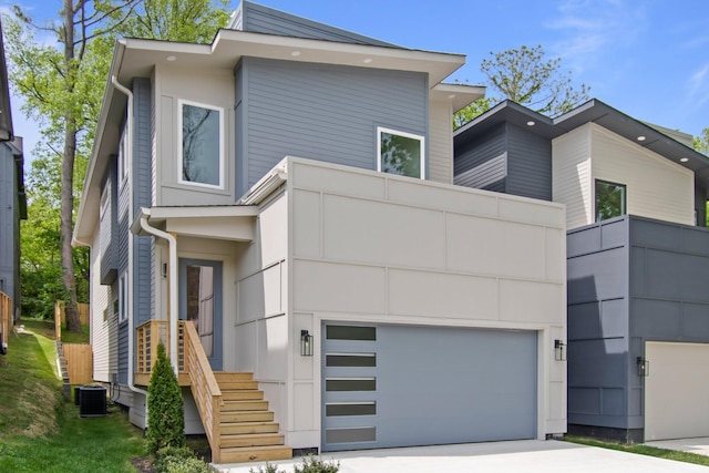 contemporary house featuring a garage and central AC unit