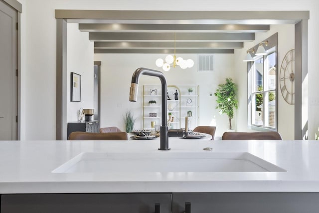 room details featuring sink and a chandelier