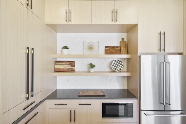 kitchen with black microwave, high end refrigerator, and light brown cabinetry