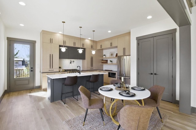 dining space with sink and light hardwood / wood-style floors