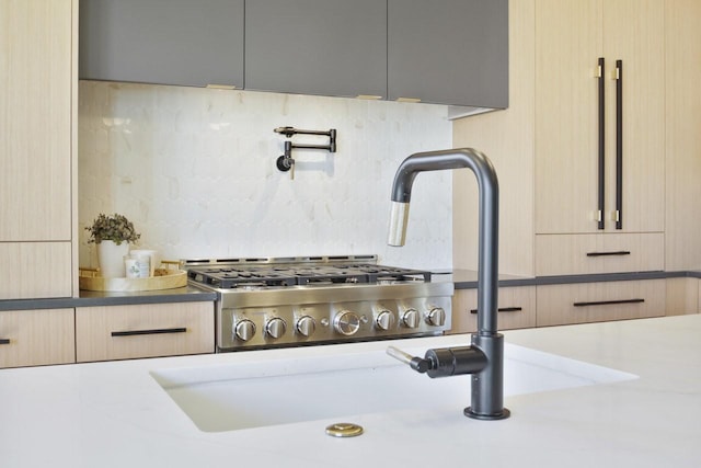 details featuring decorative backsplash and light brown cabinets